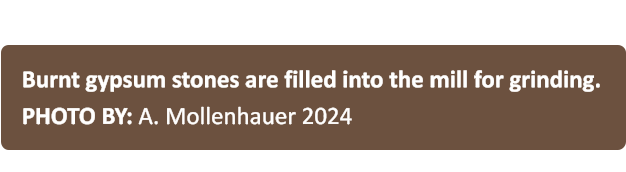 Burnt gypsum stones are filled into the mill for grinding. PHOTO BY: A. Mollenhauer 2024